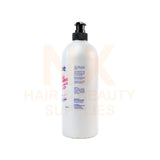 A large white bottle of hair product with a black pump dispenser, shown against a white background with a faint 'NK HAIR & BEAUTY SUPPLIES' watermark.