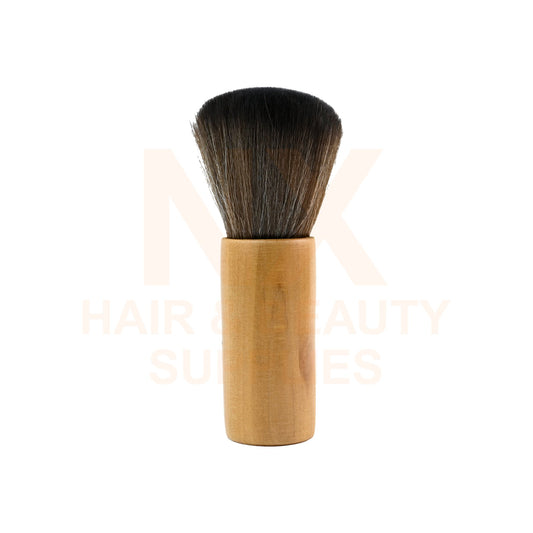 A makeup brush with dense dark brown to black bristles and a light natural wood handle, shown upright against a white background with a faint watermark.