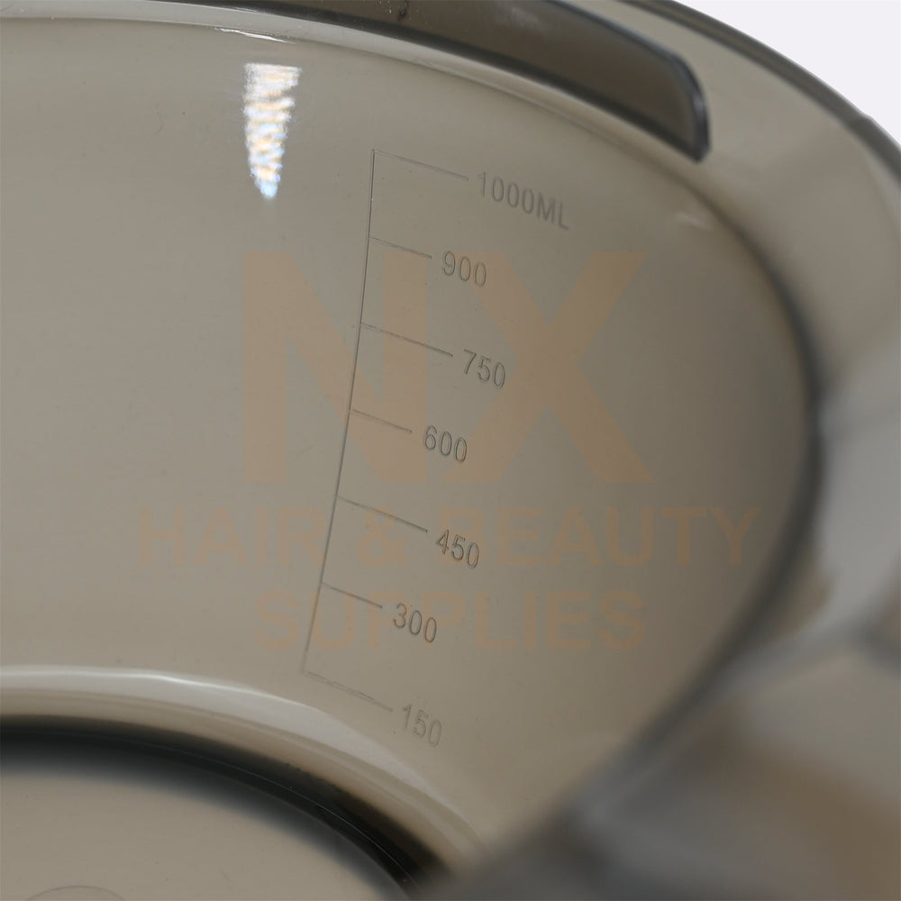 Close-up of a translucent plastic measuring container with printed volume markings from 150 to 1000ML and a large semi-transparent 'NX' logo, with 'HAIR & BEAUTY SUPPLIES' text overlaid.